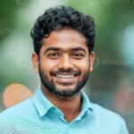 a smiling young indian man with formal shirts outdoors photo